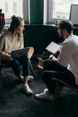 Photo by cottonbro studio: https://www.pexels.com/photo/photo-of-couple-talking-while-holding-laptop-and-ipad-4065158/